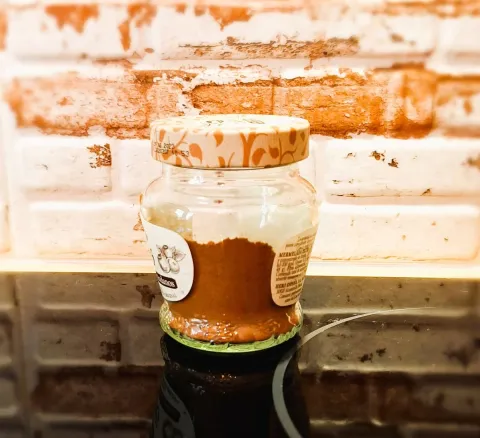 Homemade mixed spice stored in an airtight glass jar.