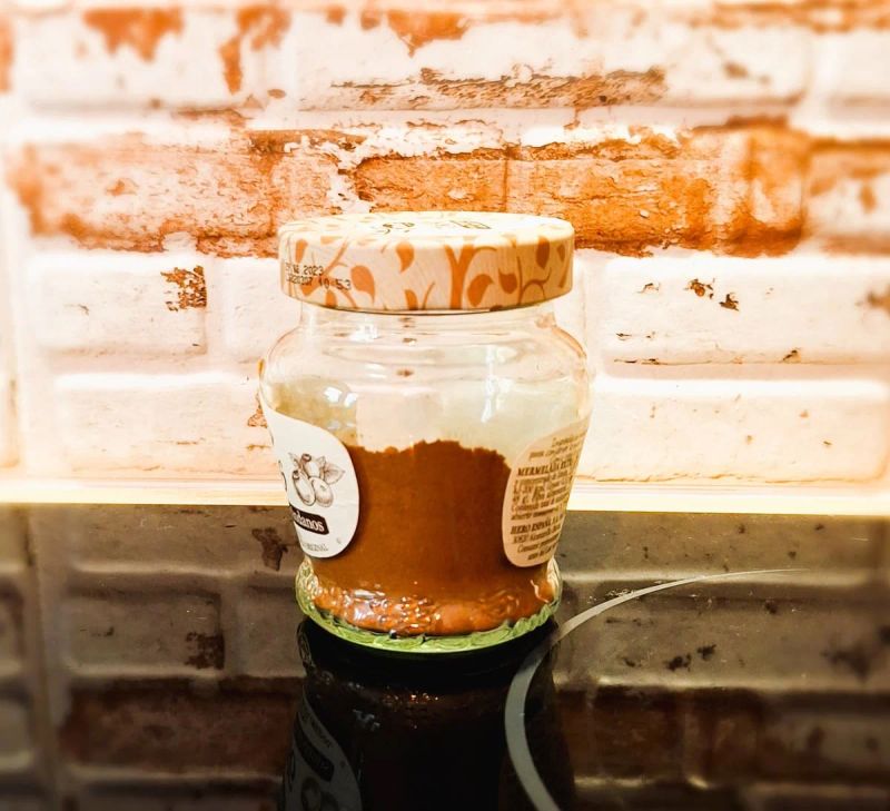 Homemade mixed spice stored in an airtight glass jar.