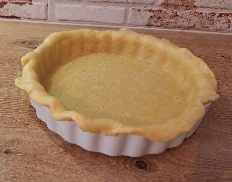 Shortcrust pastry fitted into a quiche dish with the base pricked with a fork