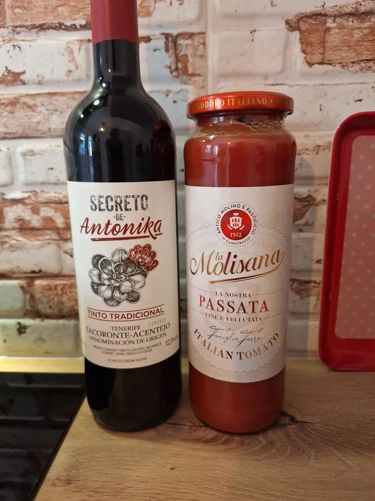 Bottle of red wine and jar of Italian tomato passata for Ragù Bolognese