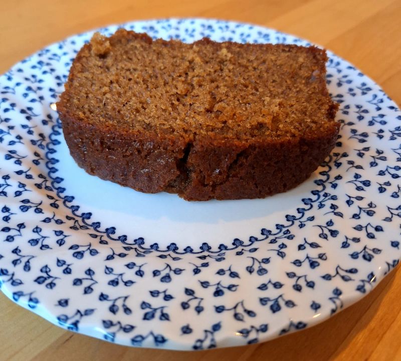 Close-up of a moist slice of homemade ginger cake served on a decorative plate.
