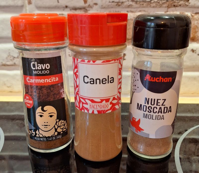 Jars of ground cloves, cinnamon and nutmeg used to make homemade mixed spice.