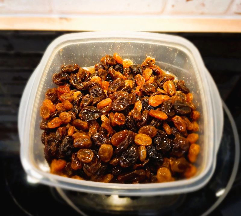 Currants and sultanas soaking in whiskey and lemon juice
