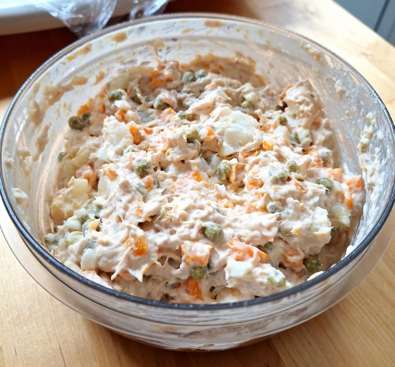Russian salad with tuna, potato, carrot and peas mixed with mayonnaise