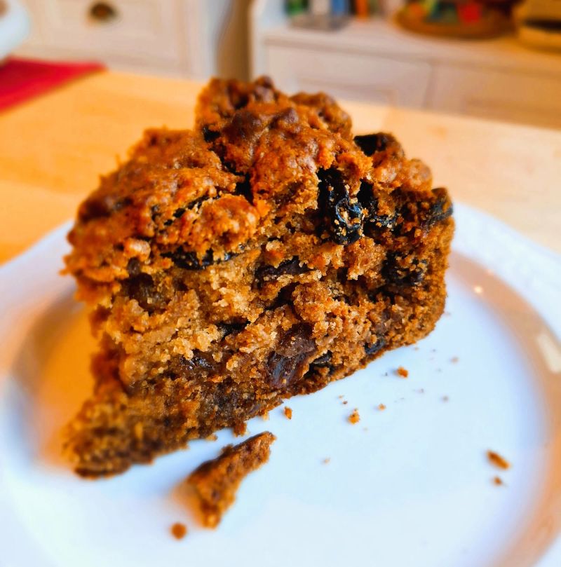 Close-up of a thick slice of whiskey tea cake filled with currants and sultanas