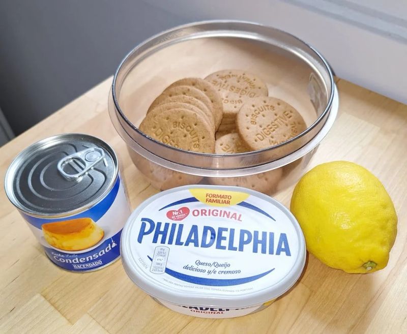 Digestive biscuits, cream cheese, condensed milk and lemon for making no-bake cheesecake