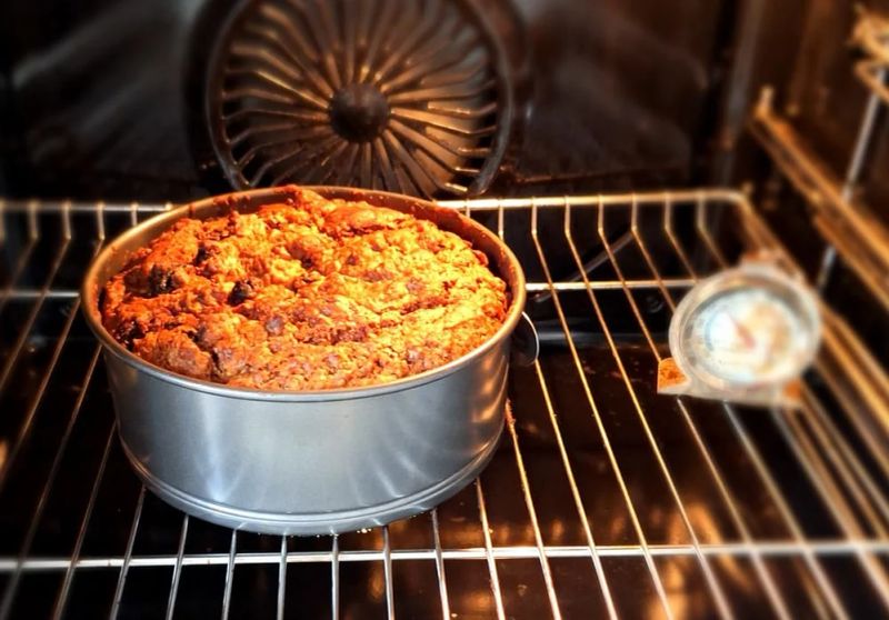 Whiskey tea cake baking in a round tin in the oven