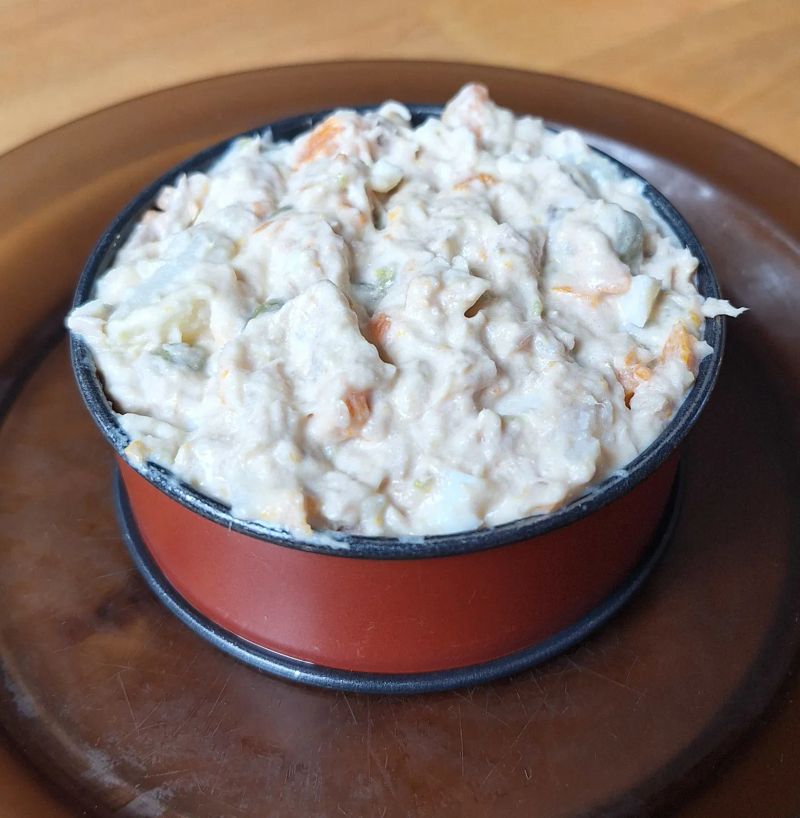 Russian salad served in a small presentation ring