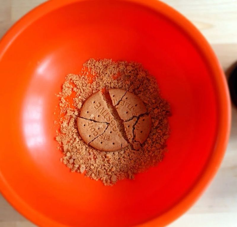 Digestive biscuits broken into pieces in a bowl ready to be crushed