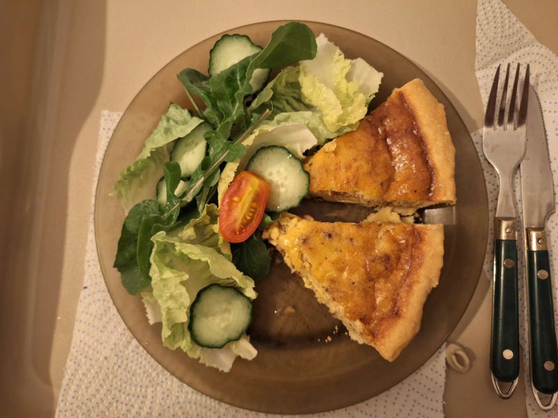 Two slices of homemade Quiche Lorraine served with a green salad
