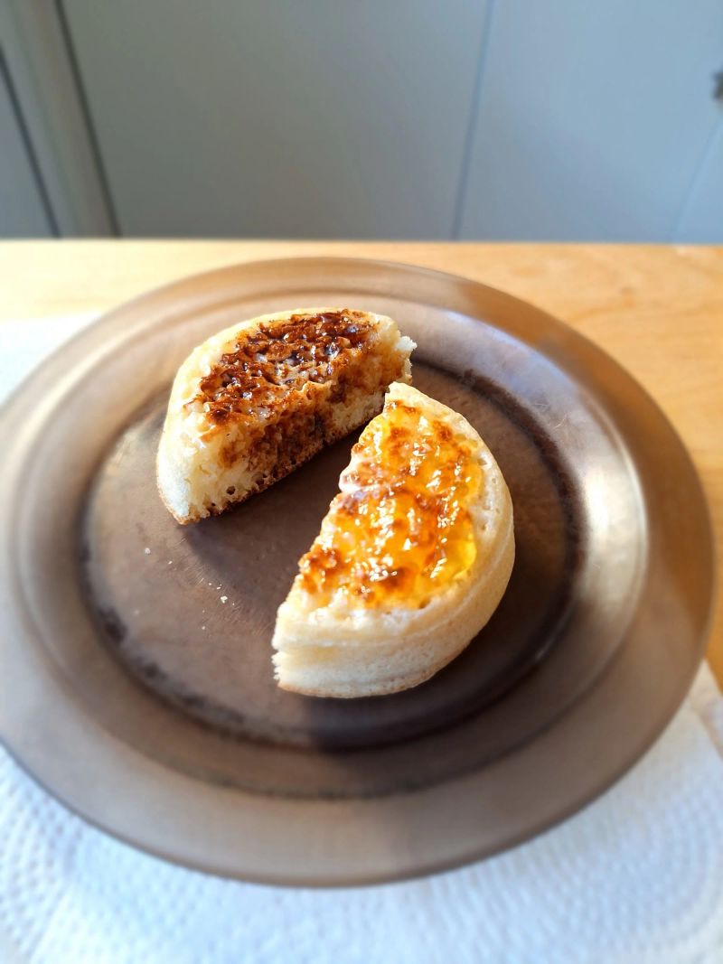 English crumpet cut in half and topped with jam and Marmite