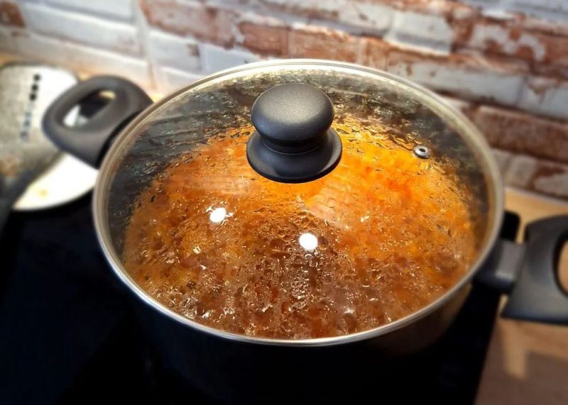 Ragù Bolognese simmering in a covered cooking pot